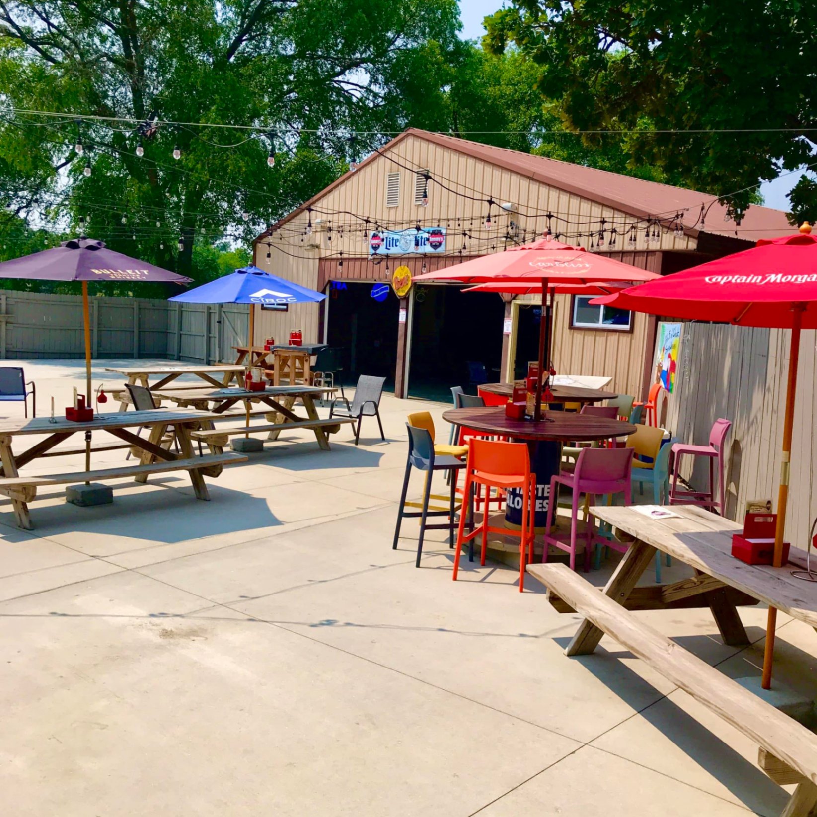 Sammy's Hill Top patio — picnic tables, umbrellas, string lights